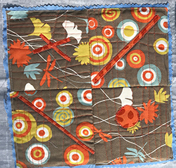 An image of quilts with red, blue, and green circle patterns